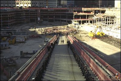 President George W. Bush and First Lady Laura Bush walk down the ramp to Ground Zero in New York City on September 11, 2002 to lay a wreath at the site.