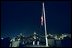 U.S. Marines lower the American flag flying over the White House to half staff at midnight Tuesday, September 10, 2002 to mark the anniversary of September 11. Pictured in the background is the Eisenhower Executive Office Building.