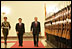 President George W. Bush and President Hu Jintao of the People's Republic of China, view Chinese troops during the welcome ceremonies for the President and Mrs. Bush at the Great Hall of People in Beijing.