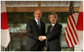 President George W. Bush and Prime Minister Junichiro Koizumi of Japan, shake hands Wednesday, Nov. 16, 2005, prior to their meeting at the Kyoto State Guest House in Kyoto, Japan.