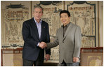 President George W. Bush and Korea President Moo Hyun Roh exchange handshakes Thursday, Nov. 17, 2005, after their meeting at the Hotel Hyundai in Gyeongju, Korea.