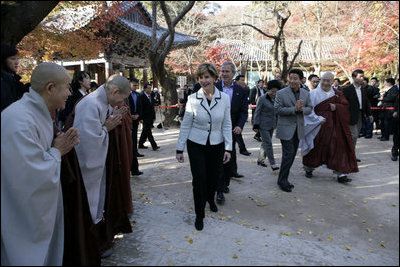 President George W. Bush and Laura Bush smile as they are greeted by monks Thursday, Nov. 17, 2005, at the Bulguksa Temple in Gyeongju, Korea.