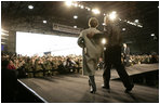 President George W. Bush and Laura Bush enter the Black Cat Hangar at Osan Air Base in Osan, Korea Saturday, Nov. 19, 2005, where the President made remarks to the troops before continuing his Asia tour.