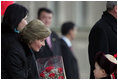 A young boy delivers a bouquet of flowers to Mrs. Bush Monday, Nov. 21, 2005, as she and President Bush joined Mongolia's President and First Lady in ceremonies in Ulaanbaatar welcoming the Bushes to Mongolia. 