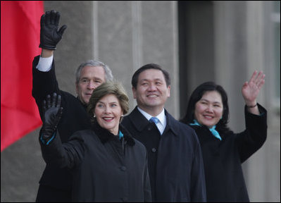 President Bush and Laura Bush join Mongolia President Nambaryn Enkhbayar and his wife, Onongiin Tsolmon, as they wave to spectators Monday, Nov. 21, 2005, during welcoming ceremonies for the Bushes in Ulaanbaatar, Mongolia. 