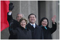 President Bush and Laura Bush join Mongolia President Nambaryn Enkhbayar and his wife, Onongiin Tsolmon, as they wave to spectators Monday, Nov. 21, 2005, during welcoming ceremonies for the Bushes in Ulaanbaatar, Mongolia. 