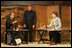 Mrs. Laura Bush receives instruction on calligraphy from Master Minoru Sawada, head calligraphy master of the Origin Arts Program, as Alex Kerr, author and Chairman of the Iori Co., looks on.