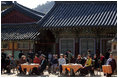 Sitting in the Korean sunlight, Laura Bush is joined by spouses of APEC leaders at the Beomeosa Temple in Busan for a morning tea ceremony.