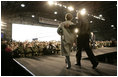 President George W. Bush and Laura Bush enter the Black Cat Hangar at Osan Air Base in Osan, Korea Saturday, Nov. 19, 2005, where the President made remarks to the troops before continuing his Asia tour.