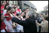 President George W. Bush reaches out to church members Sunday, Nov. 20, 2005, at the Gangwashi Church in Beijing after he and Mrs. Bush attended services.