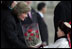 A young boy delivers a bouquet of flowers to Mrs. Bush Monday, Nov. 21, 2005, as she and President Bush joined Mongolia's President and First Lady in ceremonies in Ulaanbaatar welcoming the Bushes to Mongolia.