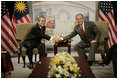 President George W. Bush and Prime Minister Abdullah Ahmad Badawi of Malaysia, exchange handshakes during their meeting Thursday, Nov. 17, 2005, at the Chosun Westin Hotel in Busan, Korea.