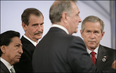 Canada's Prime Minister Paul Joseph Martin has the attention of President George W. Bush and fellow leaders of the Americas Friday, Nov. 18, 2005, as they meet at the Chosun Westin Hotel in Busan, Korea. Listening are, from left: Peru President Alejandro Toledo and Mexico President Vincente Fox.