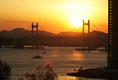 The sun sets over Busan's Gwangan Grand Bridge Friday, Nov. 18, 2005.