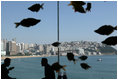 Summit-goers enjoy a beverage as they sit in the Chosun Westin Hotel in Busan, Korea Saturday, Nov. 19, 2005. In the background is Haeundae Beach and Suyeong Bay.