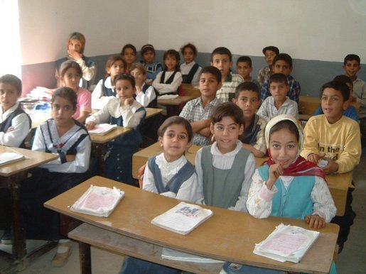 Iraqi primary school children enjoy a new day of education in their newly rehabilitated class room.