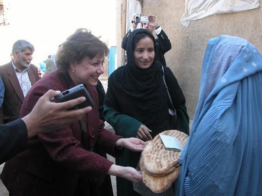 Agriculture Secretary Ann M. Veneman speaks to a woman who receives inexpensive bread from a WFP-funded women's bakery. Veneman announced, in Afghanistan, that the USDA intends to donate $5 million of U.S. agricultural commodities under the Food for Progress Program. Veneman also announced the first Cochran Fellowship Program with Afghanistan to provide short-term, U.S.-based training for eight Afghan women to study agricultural finance.