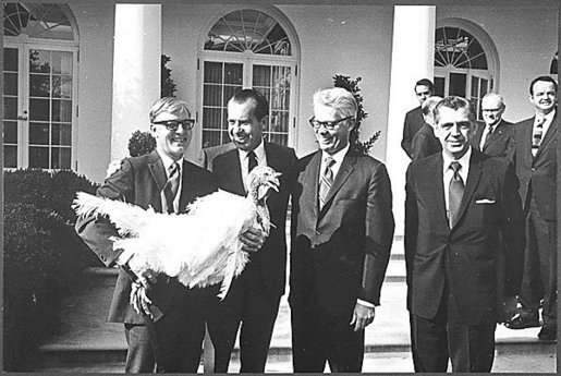 Photograph of President Nixon receiving a Thanksgiving turkey from members during the annual pardoning ceremony.