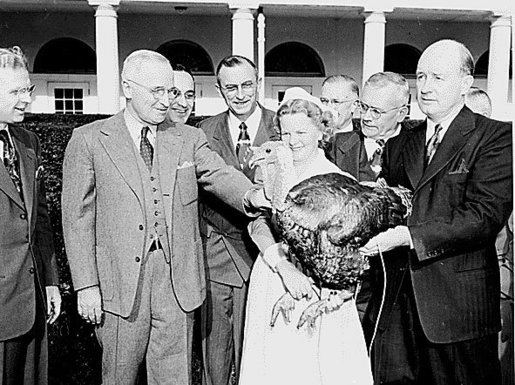  Photograph of President Truman receiving a Thanksgiving turkey from members of the Poultry and Egg National Board and other representatives of the turkey industry, outside the White House.