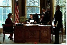 President George W. Bush meet with Karen Hughes, left, Andrew Card, center, and Karl Rove in the Oval Office Dec. 20, 2001. White House photo by Paul Morse.