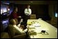 President George W. Bush meets with Karen Hughes and Karl Rove in the conference room aboard Air Force One Nov. 5, 2002. White House photo by Eric Draper.