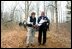 President George W. Bush looks over maps of the Wells National Estuarine Research Reserve with Manager Paul Dest in Wells, Maine, Thursday, April 22, 2004.