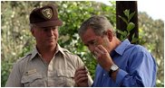 President George W. Bush smells a branch of sage with Ralph Waycott, volunteer coordinator of the Rancho Sierra Vista Nursery, during a tour of the Santa Monica Mountains National Recreation Area in Thousand Oaks, Calif. 