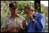 President George W. Bush smells a branch of sage with Ralph Waycott, volunteer coordinator of the Rancho Sierra Vista Nursery, during a tour of the Santa Monica Mountains National Recreation Area in Thousand Oaks, Calif. 