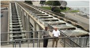 President George W. Bush talks with Witt Anderson during a tour of the Ice Harbor Lock and Dam in Burbank, Wash., Friday,August 22, 2003.