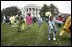 Children slip through a race with their Easter eggs during the traditional race on the South Lawn. Although rainy weather cut short the event, children and their parents made many colorful memories to brighten up a gray, gloomy day.