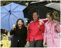 Jacalyn Leavitt, her husband, Health and Human Services Secretary Mike Leavitt and Education Secretary Margaret Spellings watch children run, fall and laugh as they run and slide on the South Lawn grass during the 2005 White House Easter Egg Roll.^M