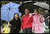 Jacalyn Leavitt, her husband, Health and Human Services Secretary Mike Leavitt and Education Secretary Margaret Spellings watch children run, fall and laugh as they run and slide on the South Lawn grass during the 2005 White House Easter Egg Roll.