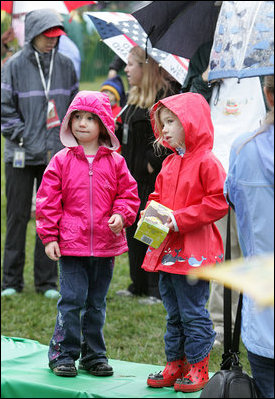 Holding a chocolate egg, two girls dress in appropriate style for the occasion. Children attending the event took part in reading corners, egg coloring, art activities, face painting and many other activities.