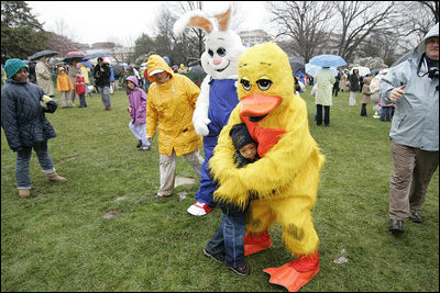 Cold days bring warm hugs as the Easter Bunny and his friends greets young visitors to a soggy South Lawn the 2005 White House Easter Egg Roll.