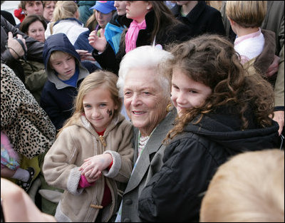 Former first lady Barbara Bush is surrounded by children as she poses for photos Monday, March 24, 2008, following her reading at the 2008 White House Easter Egg Roll, where she read "Arthur's New Puppy."