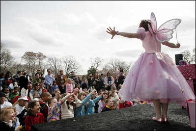 Children gather at the Magic Stage on the South Lawn of the White House to watch magician Fairy Twinkletoes perform Monday, March 24, 2008, during the 2008 White House Easter Egg Roll.