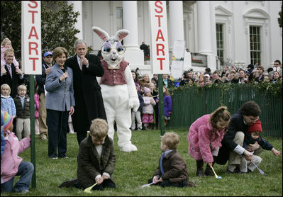 President George W. Bush, joined by Mrs. Laura Bush, blows a whistle Monday, March 24, 2008 on the South Lawn of the White House, to officially start the festivities for the 2008 White House Easter Egg Roll. 