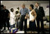 El Presidente George W. Bush conversa con unos niños el lunes, 5 de septiembre de 2005 afuera del albergue Bethany World Prayer Center, en Baton Rouge, Louisiana. El centro está proporcionando albergue a cientos de personas desalojadas por el huracán Katrina.