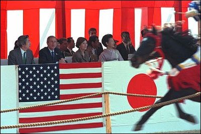 Prime Minister Junichiro Koizumi, far left, President George W. Bush, left, Laura Bush, second right, and Kiyoko Fukuda, far right, wife of the Japanese chief cabinet secretary, watch a demonstration of horseback archery during a visit to the Meiji Shrine in Tokyo, Monday, Feb. 18. White House photo by Susan Sterner.