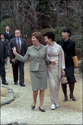 Mrs. Bush waves to members of the media and onlookers as she walks with Kiyoko Fukuda following a lunch and tea ceremony at Akasaka Palace Monday, February 18, 2002 in Tokyo. White House photo by Susan Sterner.