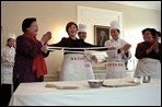 Mrs. Bush tries her hand at making fresh noodles during a Xian Culinary demonstration at the home of the U.S. Ambassador to China Thursday, February 21 2002 in Beijing. White House photo by Susan Sterner.