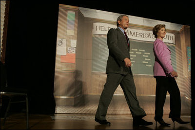 The President and Mrs. Bush arrive on stage at Paul Public Charter School in Washington DC Friday, April 1, 2005. The first lady introduced the president who spoke to the audience about his Helping America's Youth initiative.