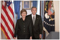 President George W. Bush and Mrs. Laura Bush walk into the Cross Hall prior to the President giving remarks on the death of Pope John Paul II at the White House on Saturday April 2, 2005.