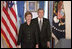 President George W. Bush and Mrs. Laura Bush walk into the Cross Hall prior to the President giving remarks on the death of Pope John Paul II at the White House on Saturday April 2, 2005.