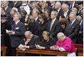 President George W. Bush and Laura Bush stand amidst mourners at funeral services Friday, April 8, 2005, for the late Pope John Paul II in St. Peter's Square. The funeral is being called the largest of its kind in modern history.