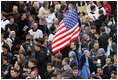 An American flag flies high above the throng of mourners inside St. Peter's square Friday, April 8, 2005, as thousands attend funeral mass for Pope John Paul II, who died April 2 at the age of 84.