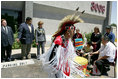 Laura Bush listens to a drumming performance by Native American children before touring the Native American Community Health Center Phoenix, Ariz., April 26, 2005. The center provides health care and other outreach services such as traditional ceremony training, dental care, women's wellness programming and case management services to Phoenix-area Native Americans.