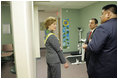 Dr. Babak Nayeri, Medical Director of the Native American Community Health Center, and Marcus Harrison, CEO of the Native American Community Health Center, give Laura Bush a tour of the Native American Community Health Center in Phoenix, Ariz., April 26, 2005.