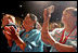 People cheer for Laura Bush after her remarks at the Heard Museum in Phoenix, Ariz., April 26, 2005.