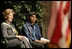 Laura Bush sits with 16-year-old Derwin Tekala, a participant in the Red Road Youth Empowerment Project, before delivering remarks at the Heard Museum in Phoenix, Ariz., April 26, 2005. Mrs. Bush discussed the role of strong family and cultural bonds in helping children resist negative social pressures.